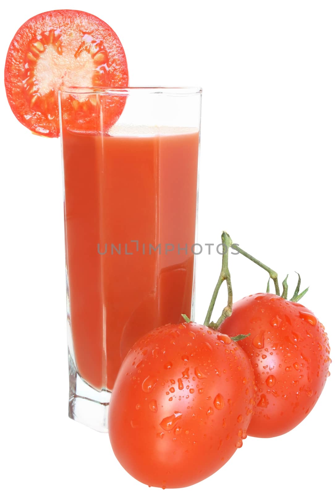 Glass of tomato juice and two tomatoes.