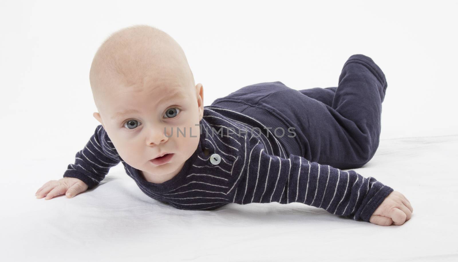 cheerful baby trying to get around. horizontal image, studio shot