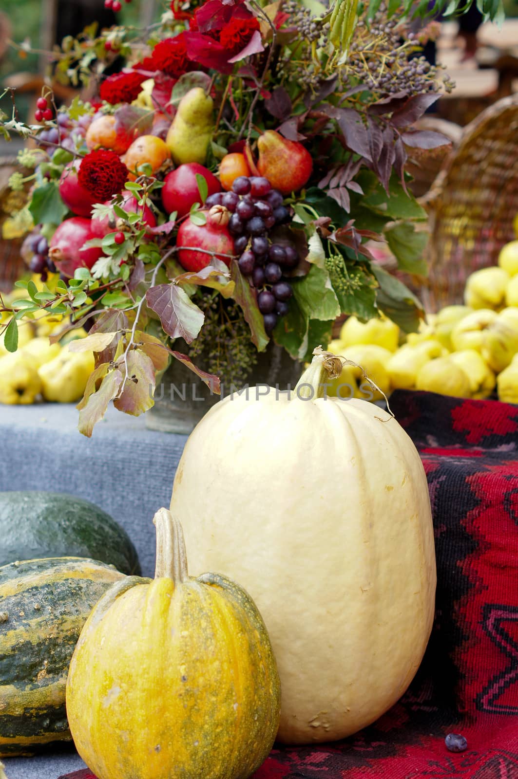 Harvested pumpkins with fall flowers on the background