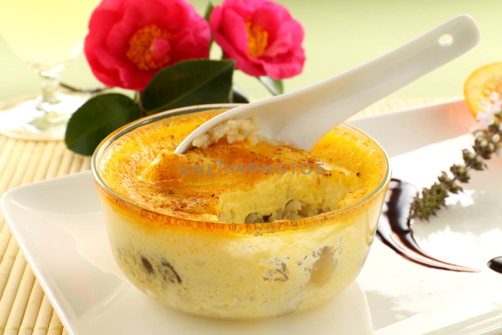 Fresh baked rice custard with a spoon straight from the oven ready to serve.