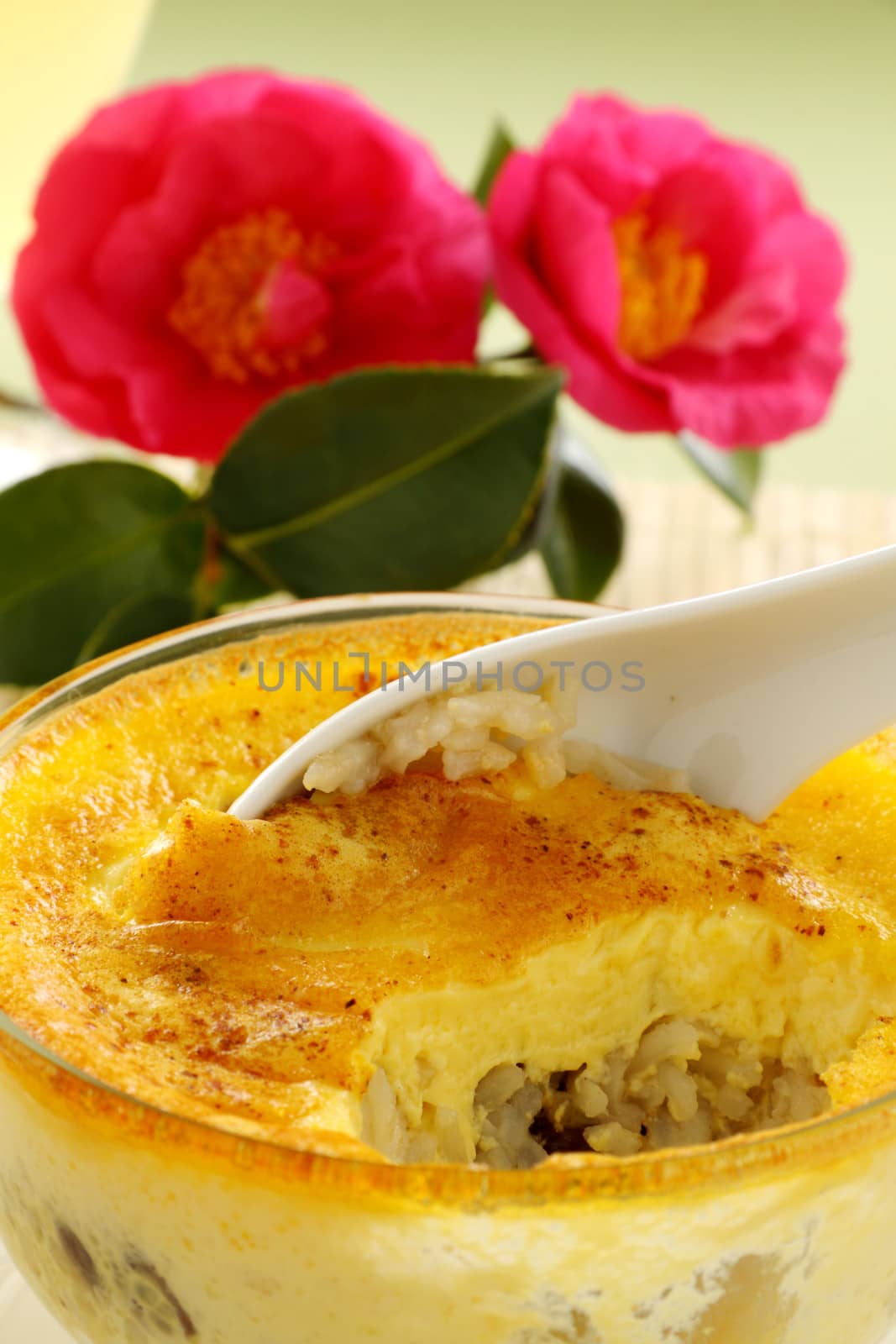 Fresh baked rice custard with a spoon straight from the oven ready to serve.