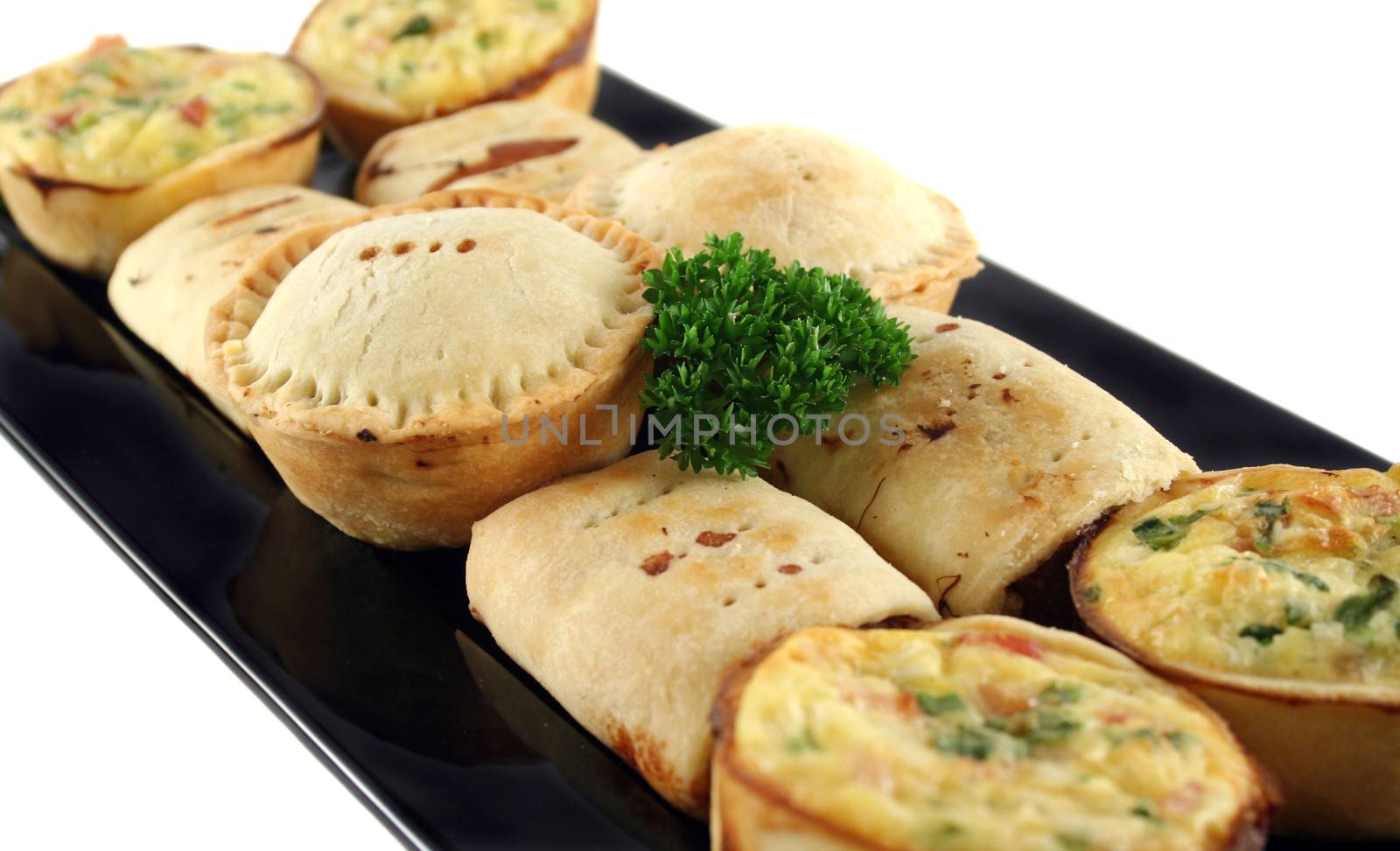 Delicious home baked snack size meat pies, sausage rolls and quiches.