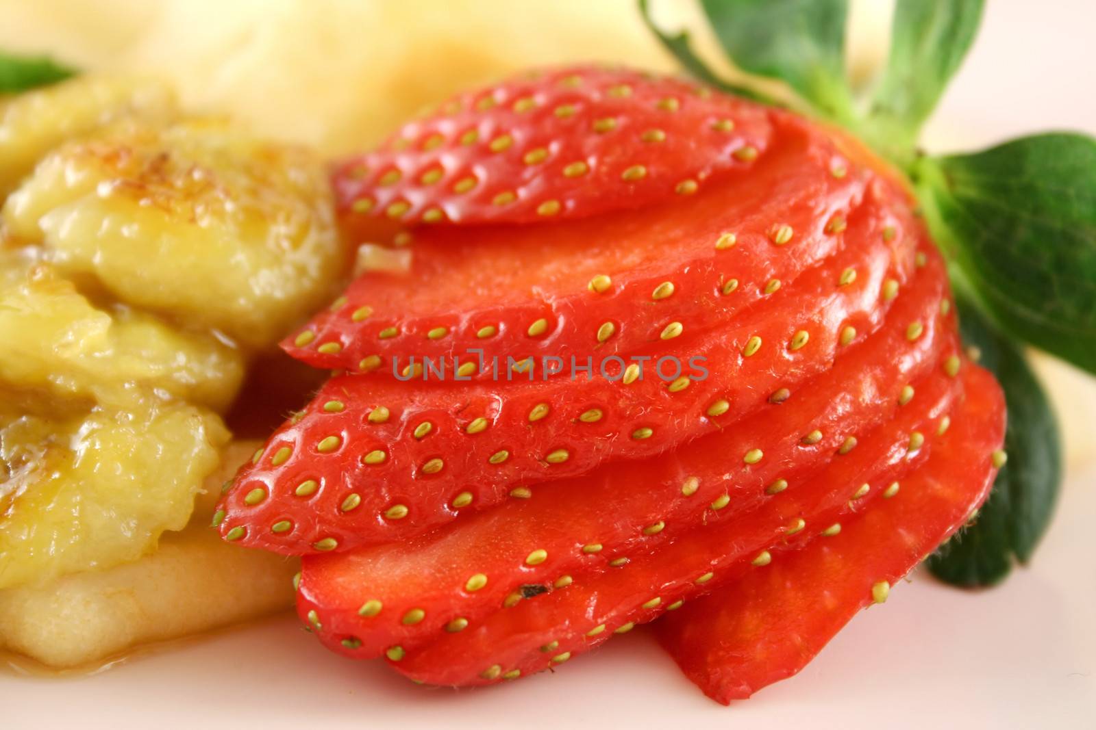 Caramelized banana crepes with strawberries and kiwi fruit and butterscotch sauce.