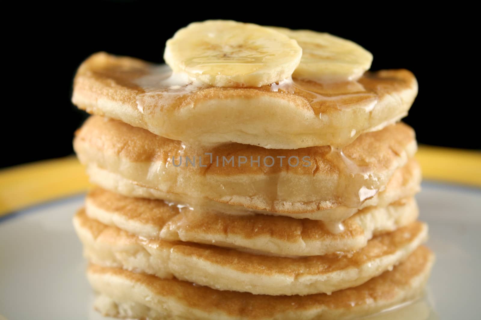 Delicious pancakes with banana, honey and ice cream.