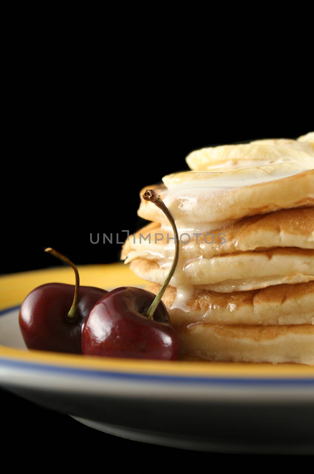 Delicious pancakes with banana, honey and ice cream.