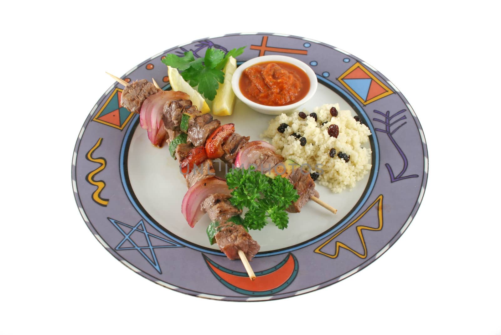 Beef kebabs and currant couscous with harissa sauce.