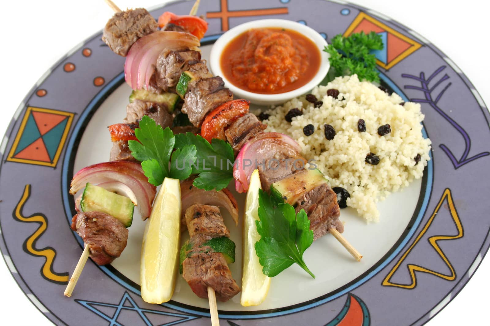 Beef kebabs and currant couscous with harissa sauce.