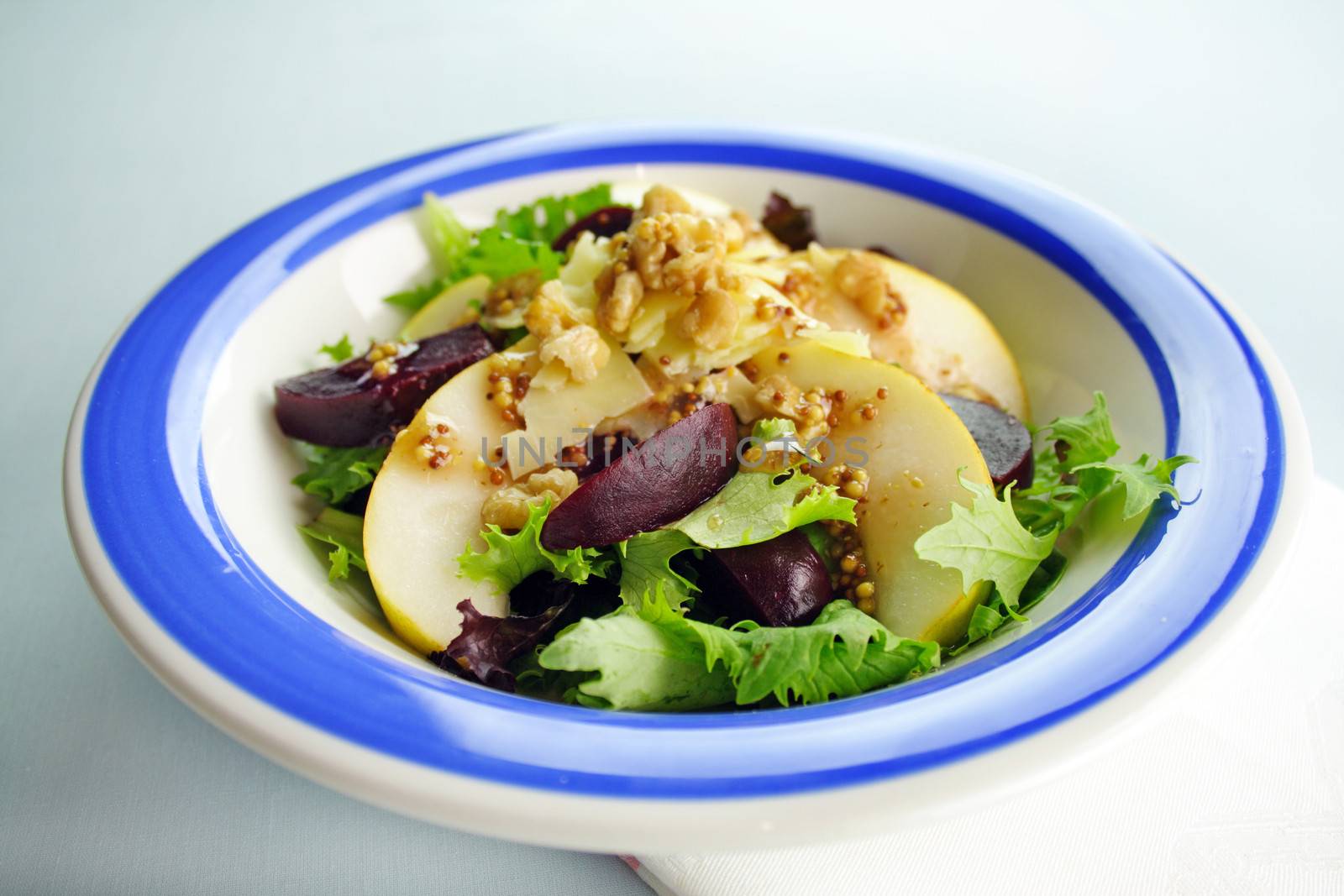 Delicious freshly made pear, beetroot and walnut salad ready to serve.