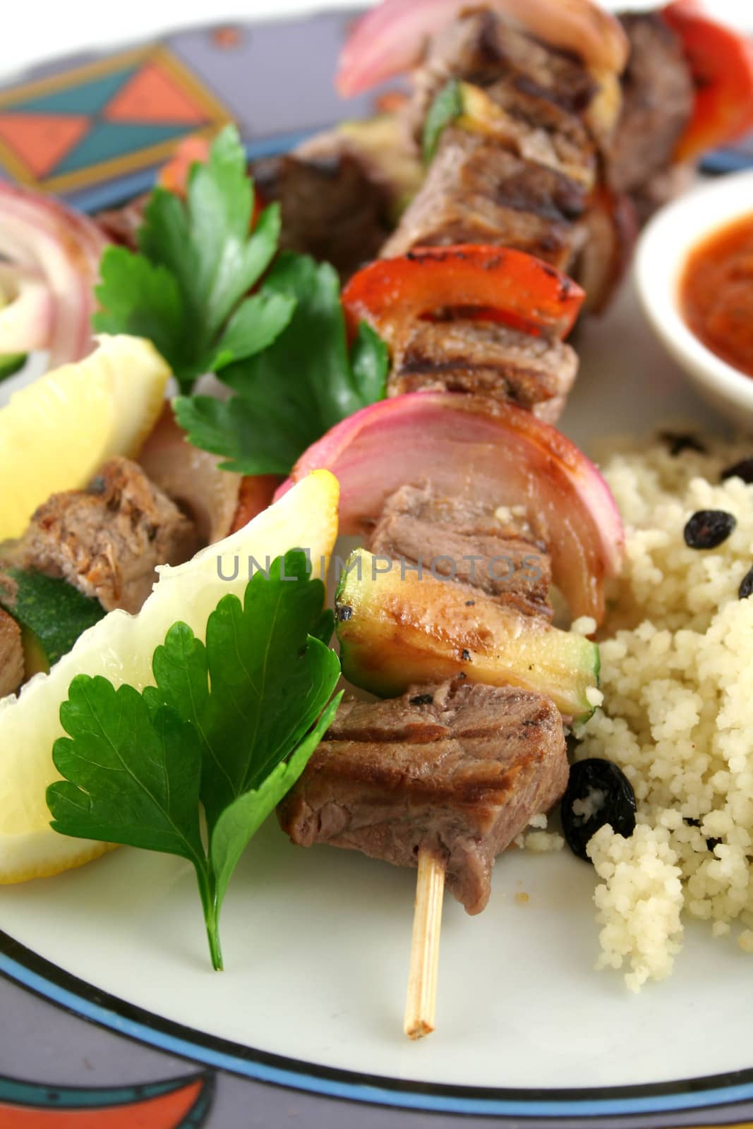 Beef kebabs and currant couscous with harissa sauce.
