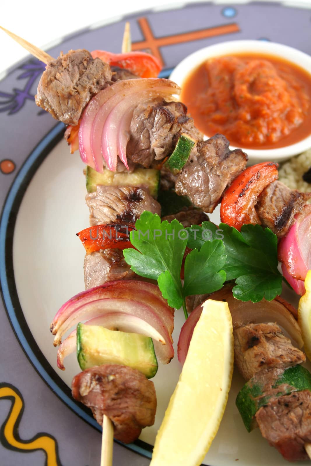 Beef kebabs and currant couscous with harissa sauce.