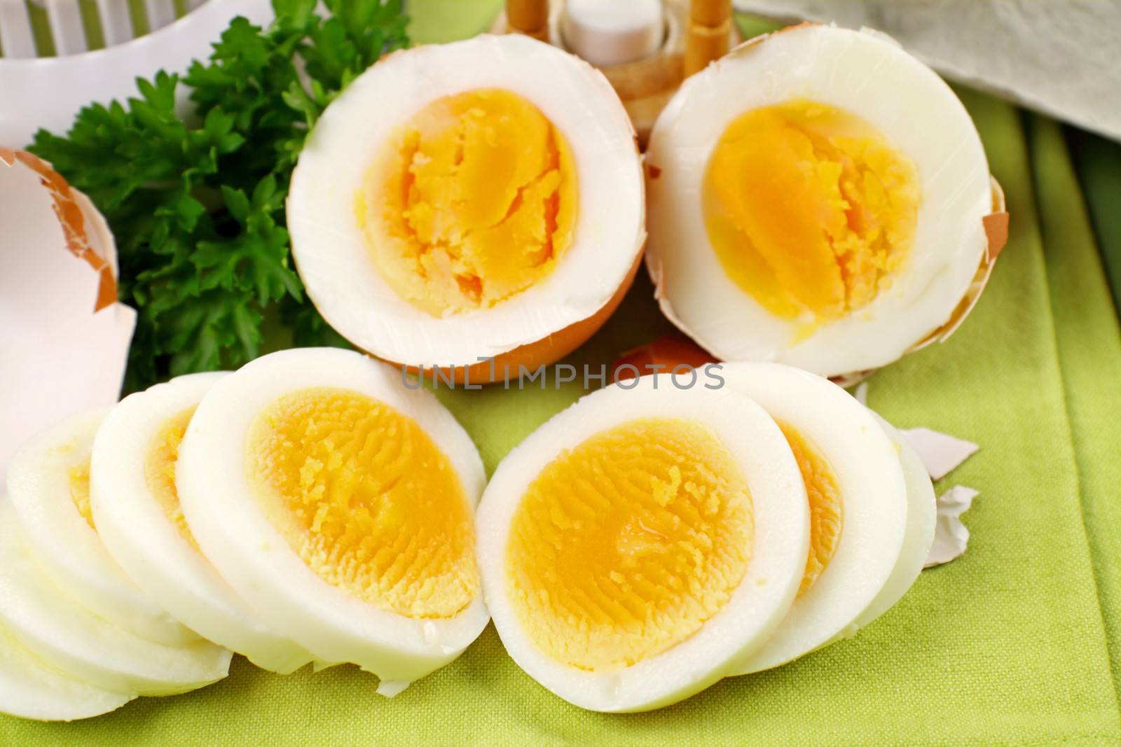 Fresh hard boiled eggs sliced and broken with parsley.