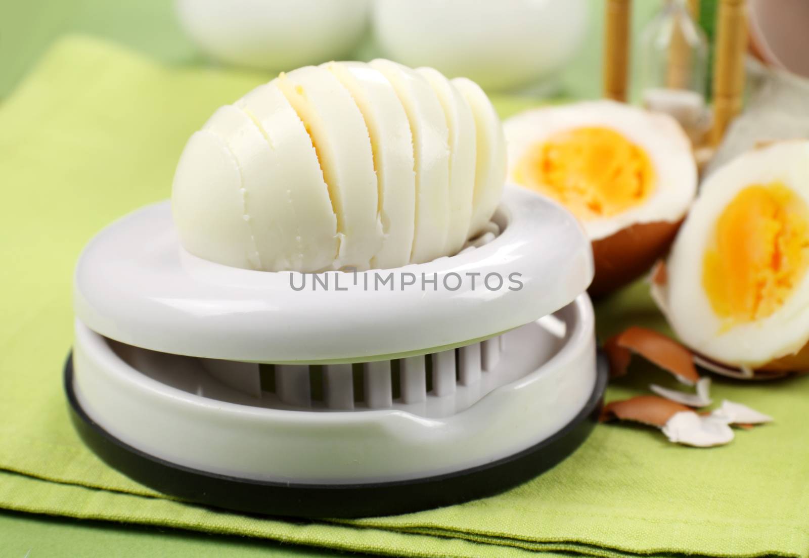 Fresh boiled sliced with an egg slicer with other eggs.