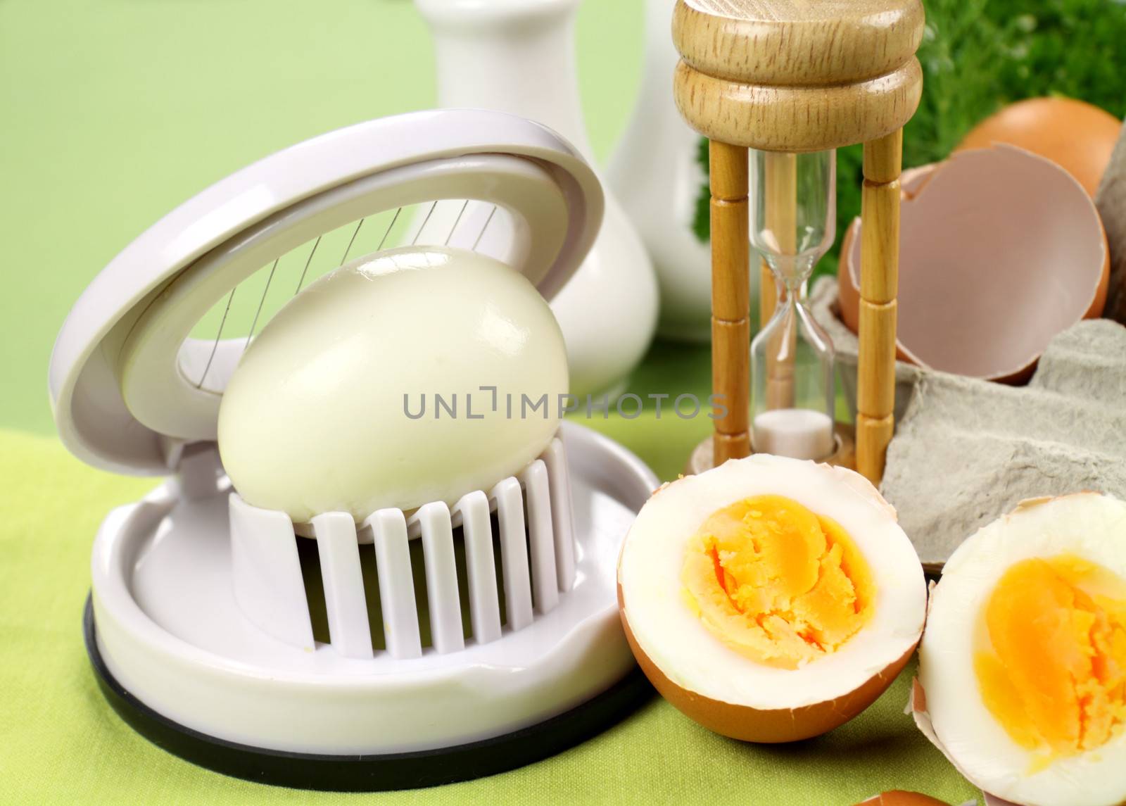 Egg slicer with boiled eggs and an egg timer.