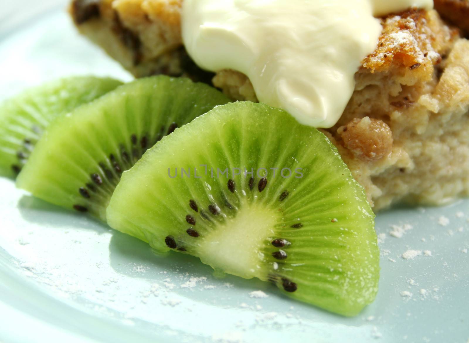 Kiwi fruit garnish with bread and butter pudding.