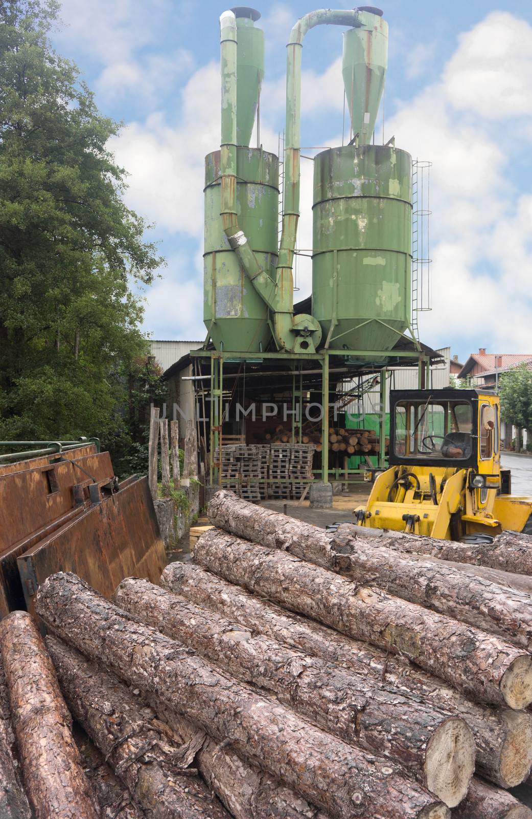 Pile of logs in front of a lumber mill