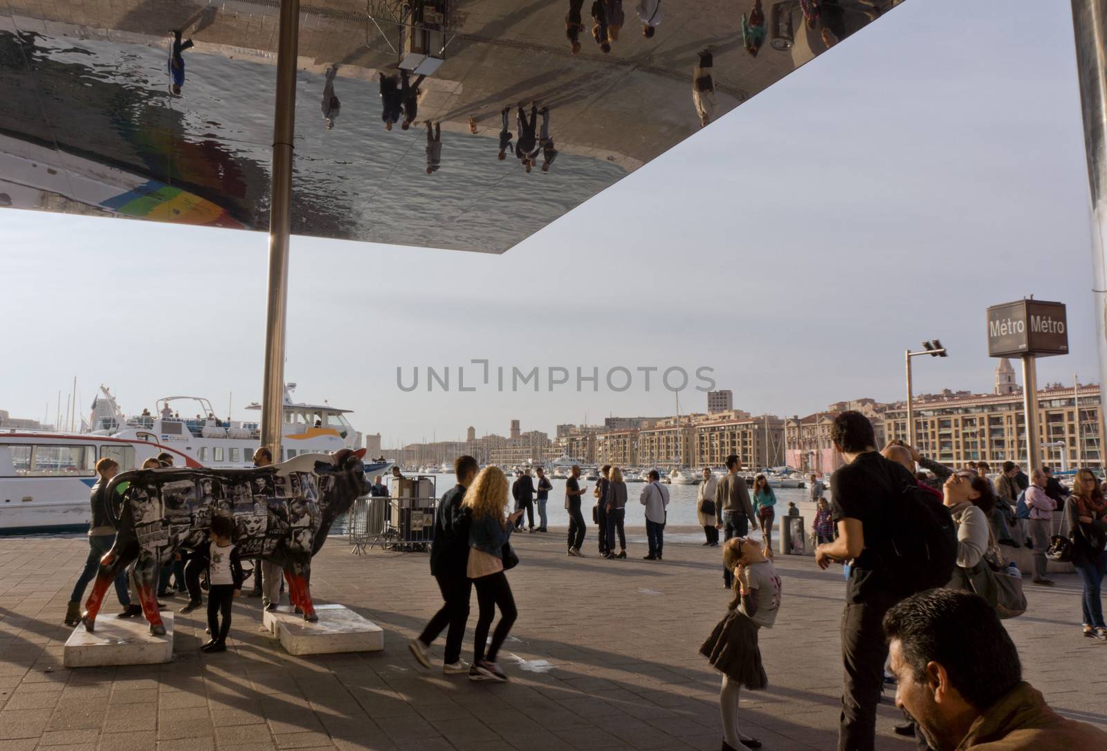 Marseille, France - 2013, November 1: Tourists having fun under the glass roof of the old port of Marseille.  On November 2013 in Marseille, France.