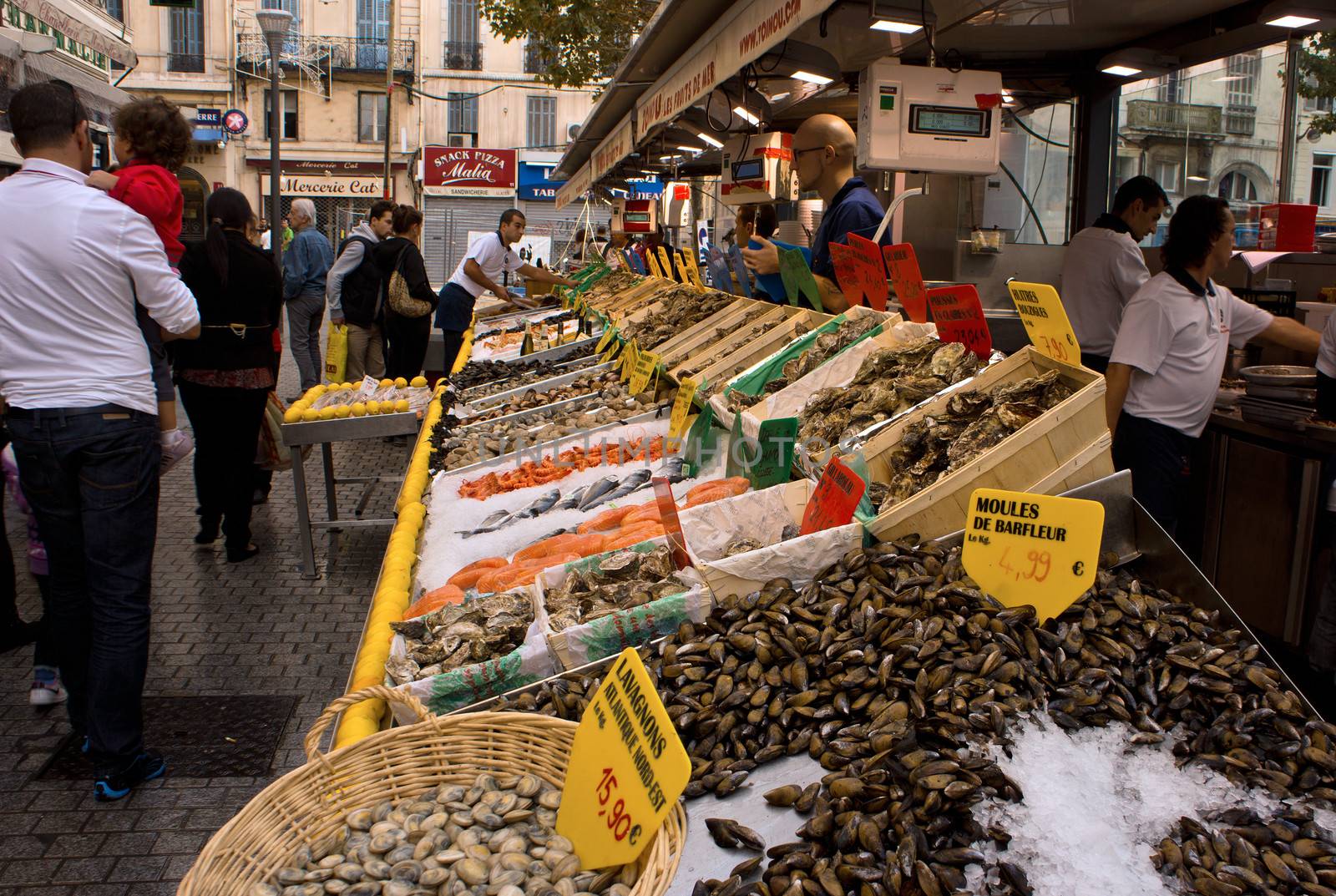 Marseille, France - 2013, November 2: People buying and selling seafood in a street market. On Marseille, France, on November 2, 2013.
