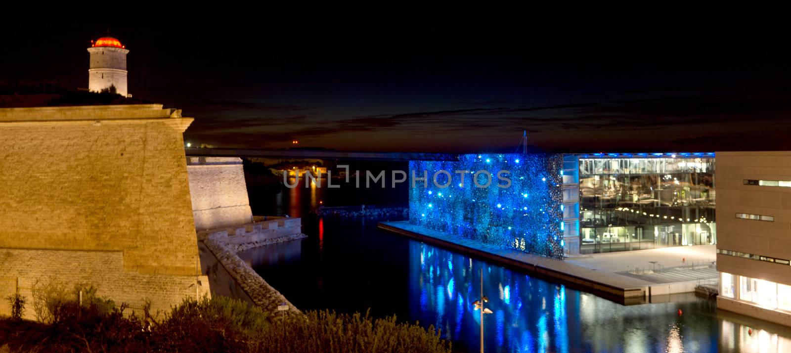 Marseille, France - 2013, November 2: A night view of the new revitalized area of the old port of Marseille. Next to the Fort St.-Jean, two of the new museums inaugurated this year for the Marseille European Capital of Culture 2013 event: the MuCEM and Villa Mediterranée.  On November 2013 in Marseille, France.