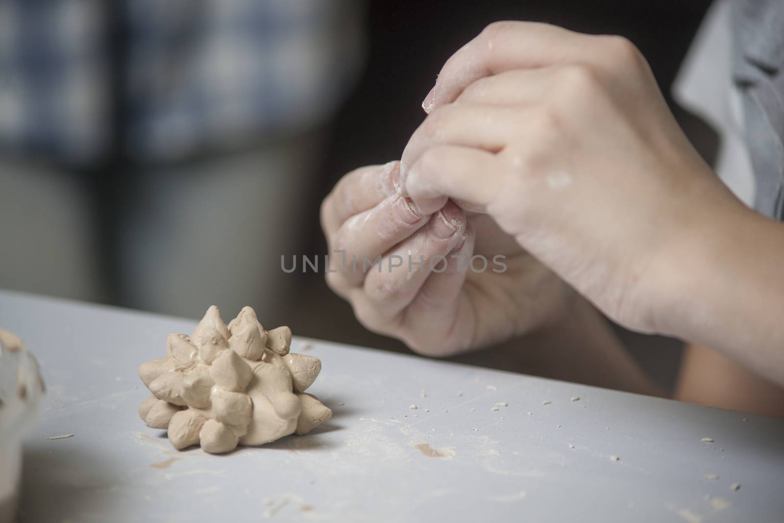 Girl make toyfrom clay. High resolution image.