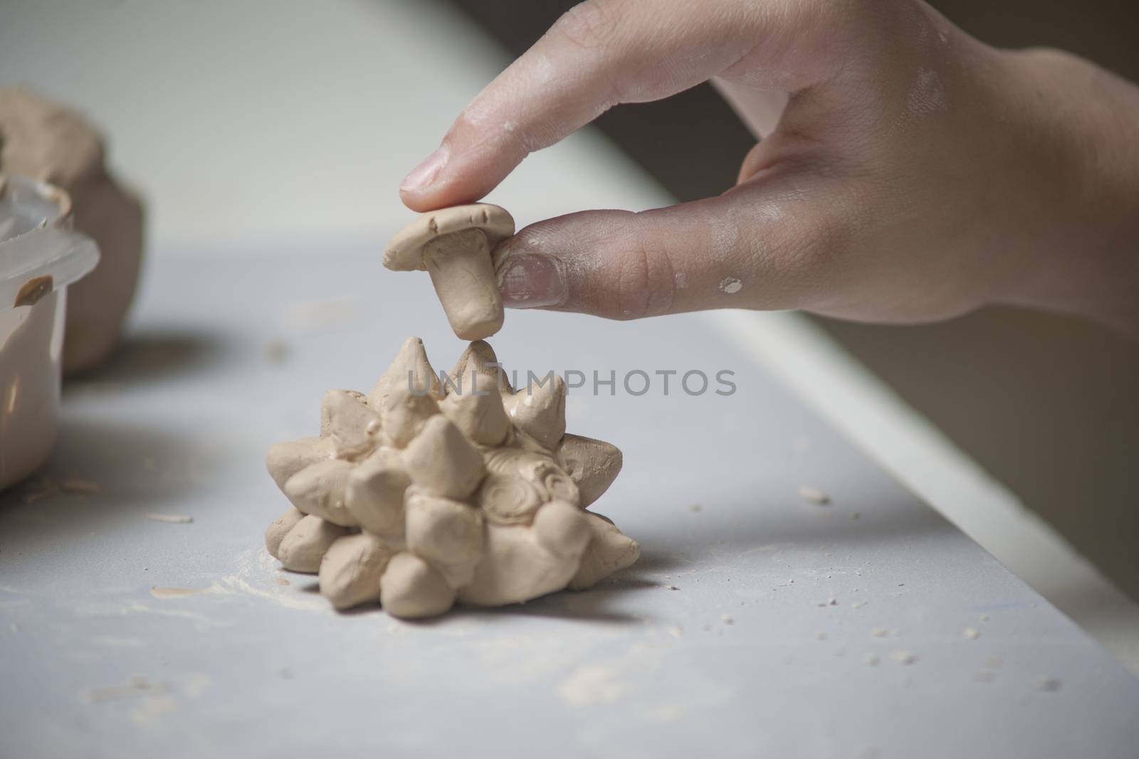 Girl make toyfrom clay. High resolution image.