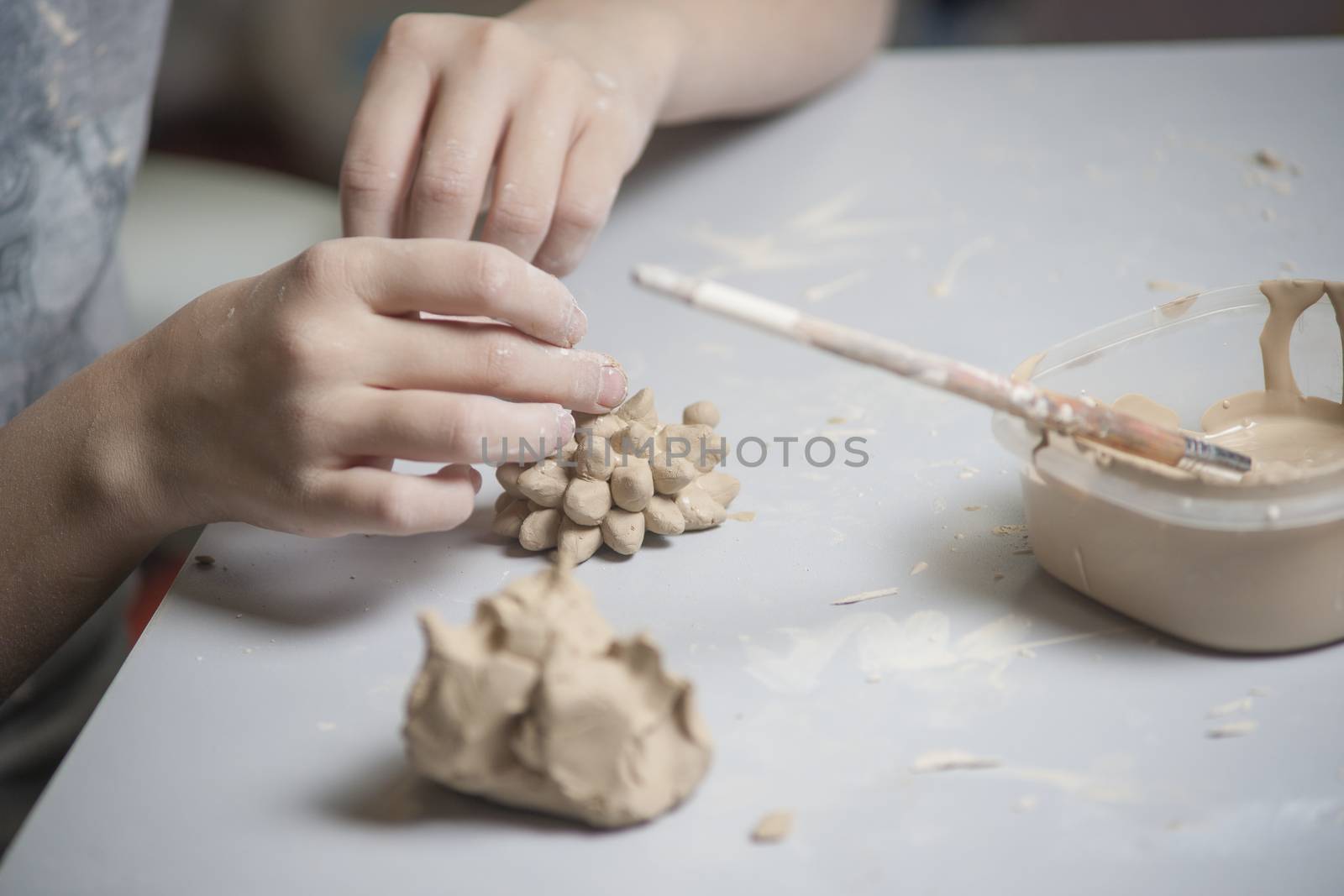 Girl make toyfrom clay. High resolution image.