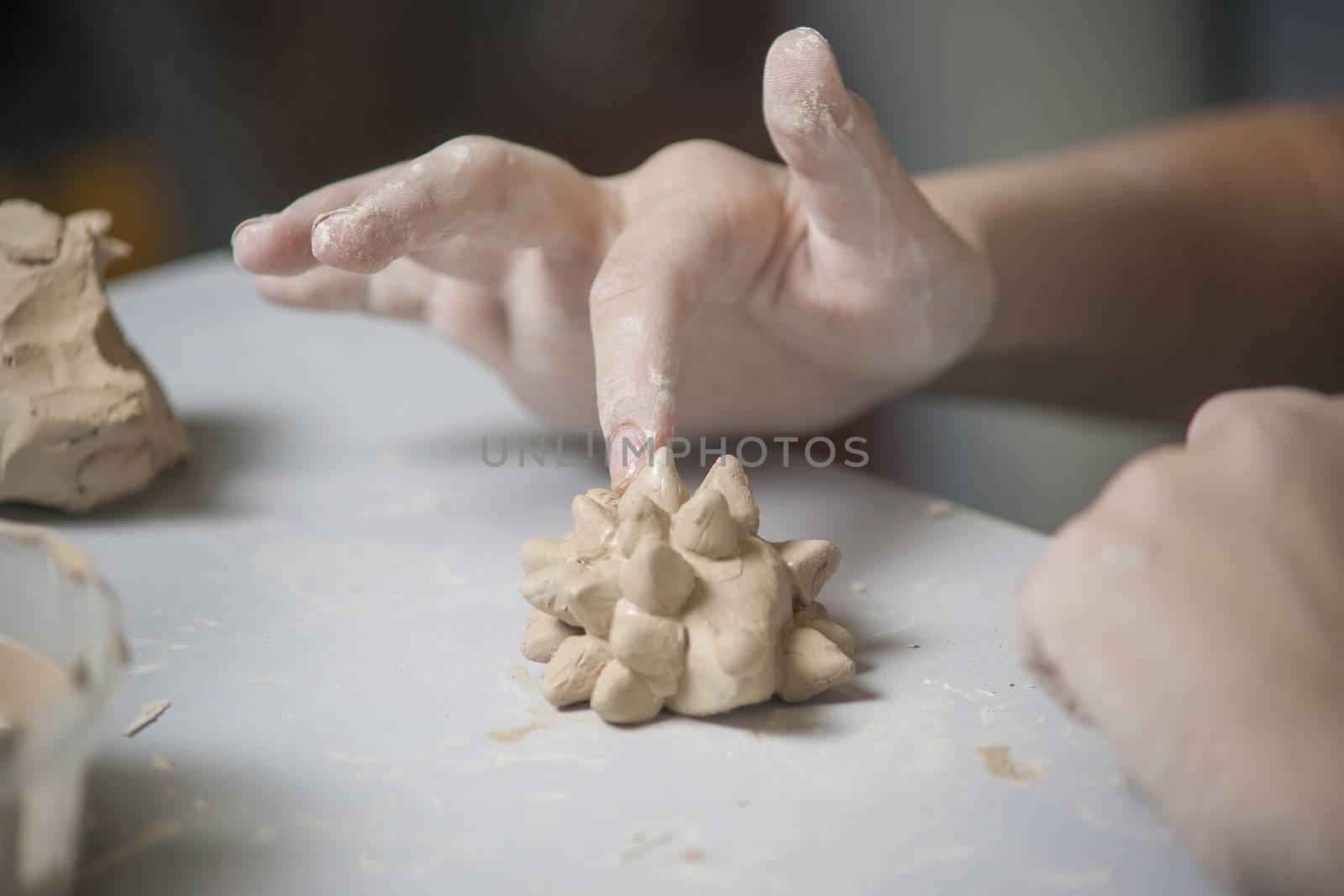 Girl make toyfrom clay. High resolution image.
