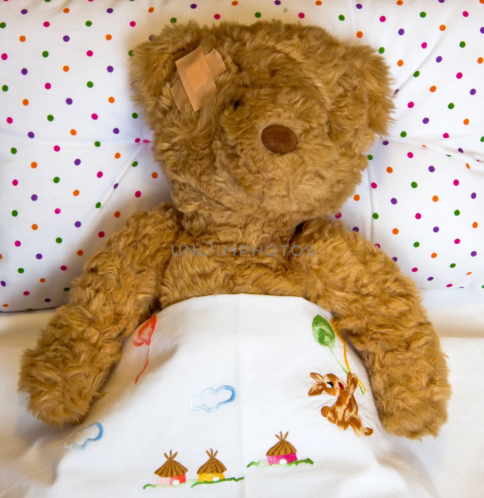 ill teddy bear in bed