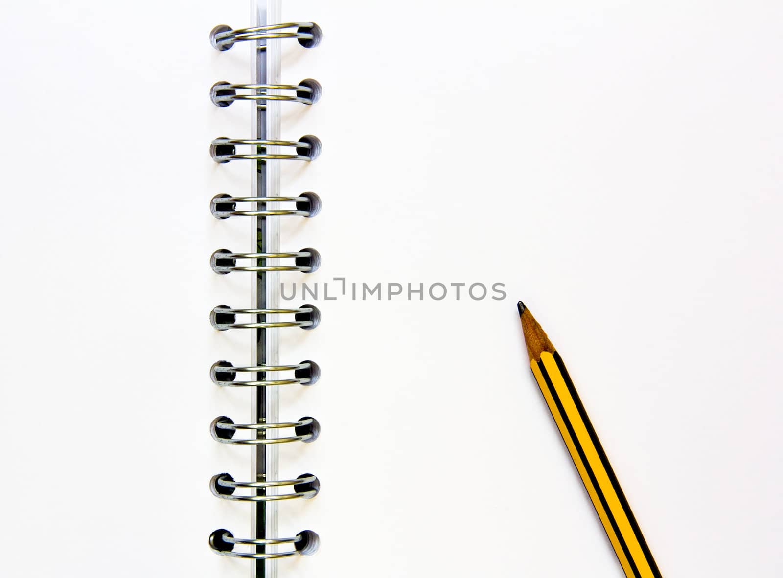 open blank notepad with rings and pencil