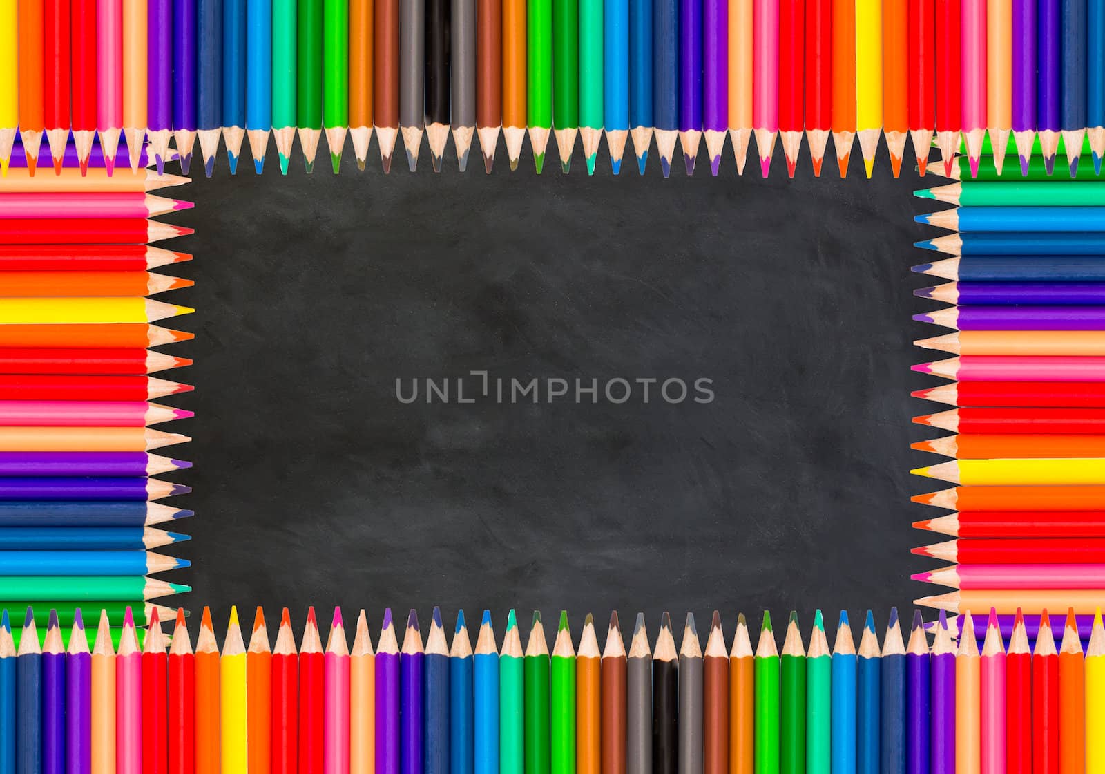 colored pencils on black chalkboard background