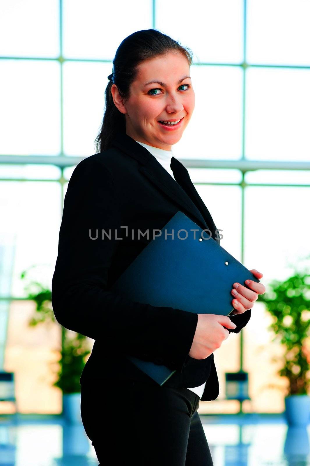 Young happy business woman holding a folder office