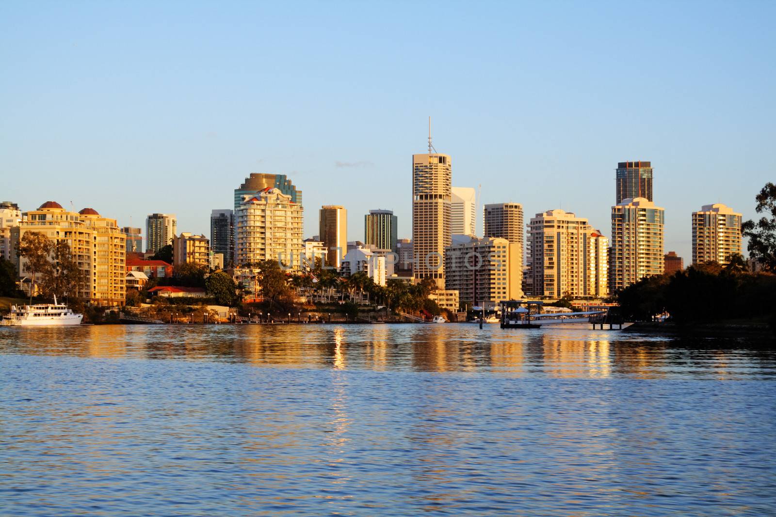 Brisbane city skyline approaching Dockside from the Brisbane River just after dawn.