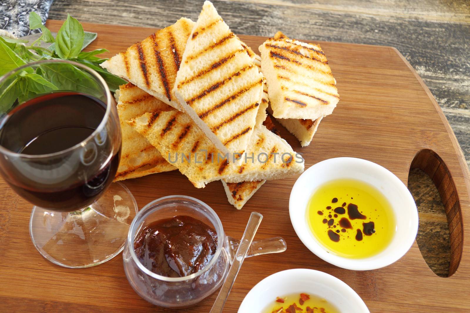 A selection of Italian finger food with grilled brushetta and dips with olive oil and chillies.