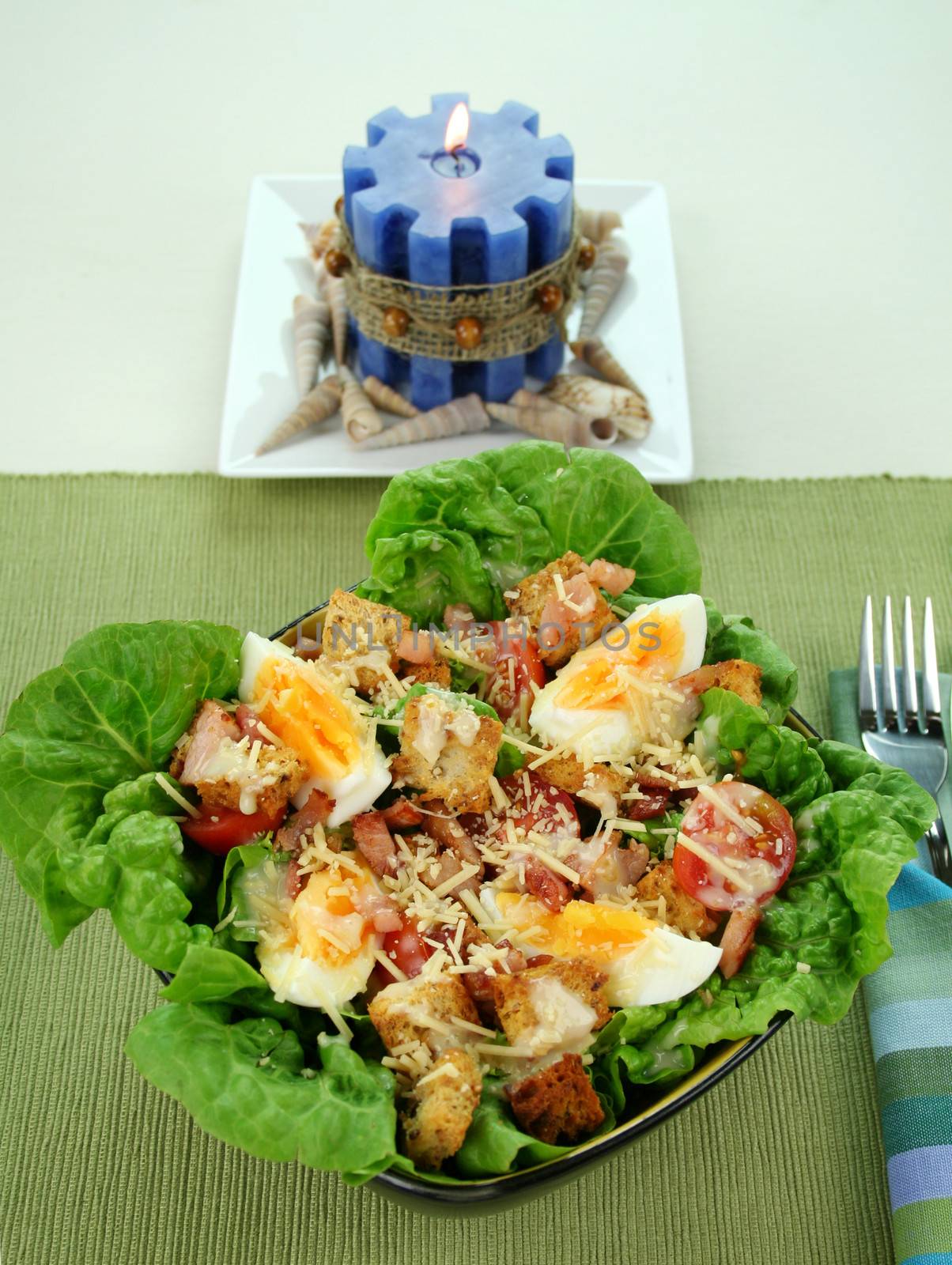 Fresh Caesar salad with lettuce, cherry tomatoes, parmesan cheese, egg, bacon and croutons.