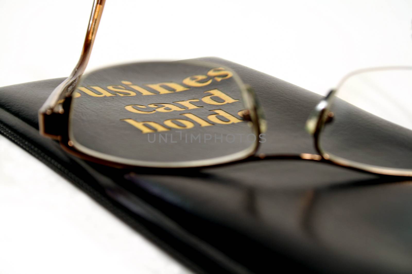 Business card holder focussed through glasses.