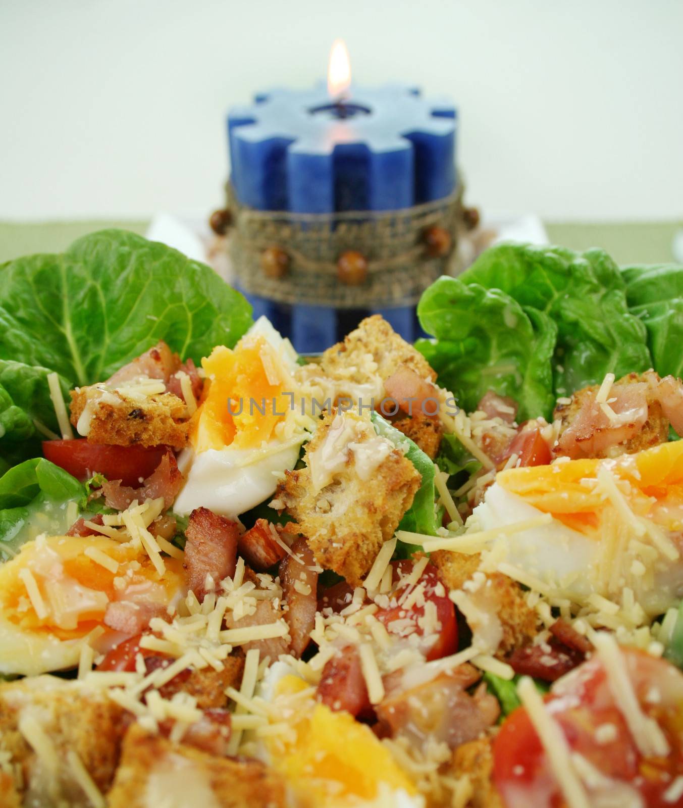 Fresh Caesar salad with lettuce, cherry tomatoes, parmesan cheese, egg, bacon and croutons.