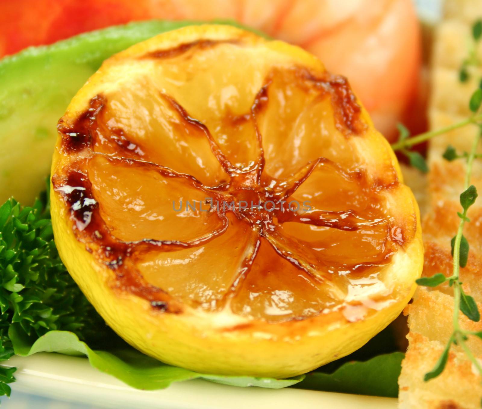 Delicious grilled caramelized lemon served with fresh seafood.