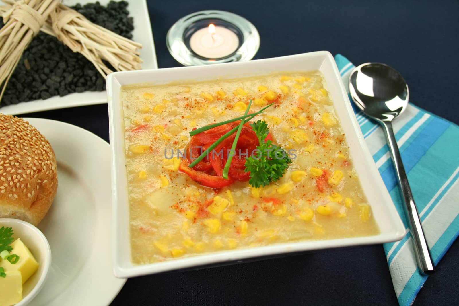 Roasted capsicum chili and corn chowder in a table setting.