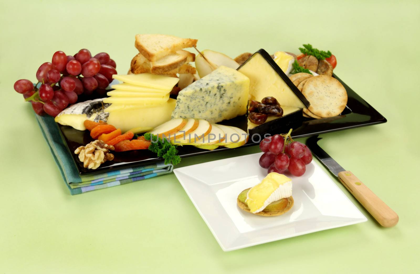 Delicious cheese platter with various cheeses and fruits ready to serve.