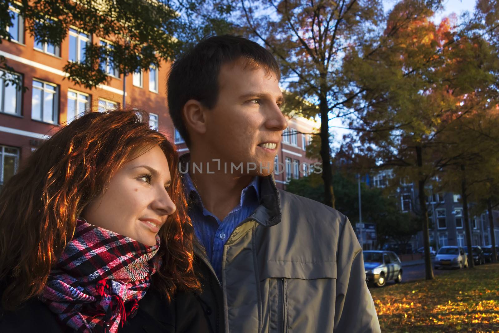 Outdoor happy couple in love posing against autumn Amsterdam background