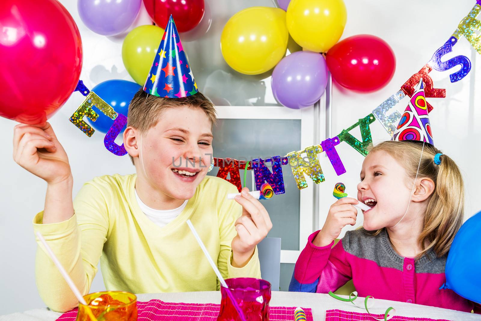 Happy little children are having fun in a birthday party 