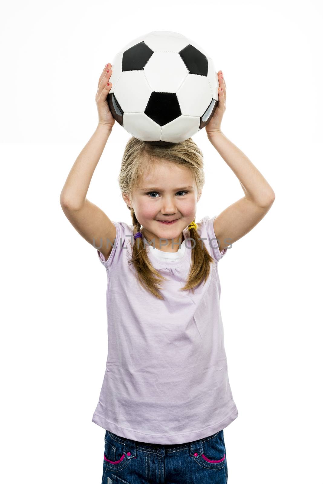 Cute girl playing football, happy child, young female goalkeeper enjoying sport game, holding ball, isolated portrait of a preteen smiling and having fun, kids activities, little footballer 