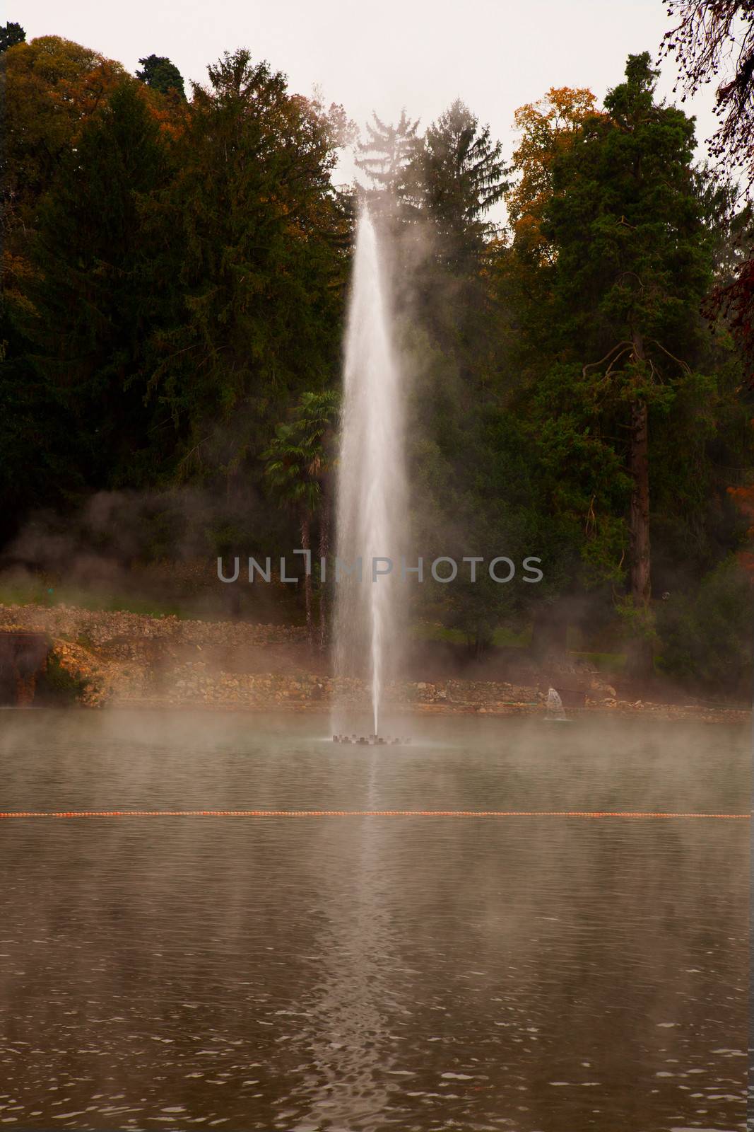 Big high fountain in the middle of a smokey thermal lake