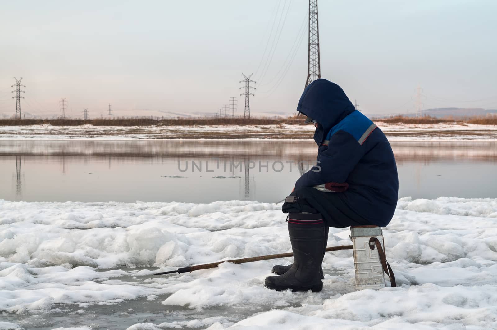 The fisherman on winter fishing fishes