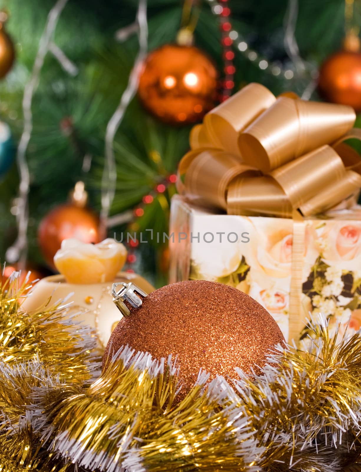 Christmas toy gift for decoration and candle on a festively decorated Christmas tree background