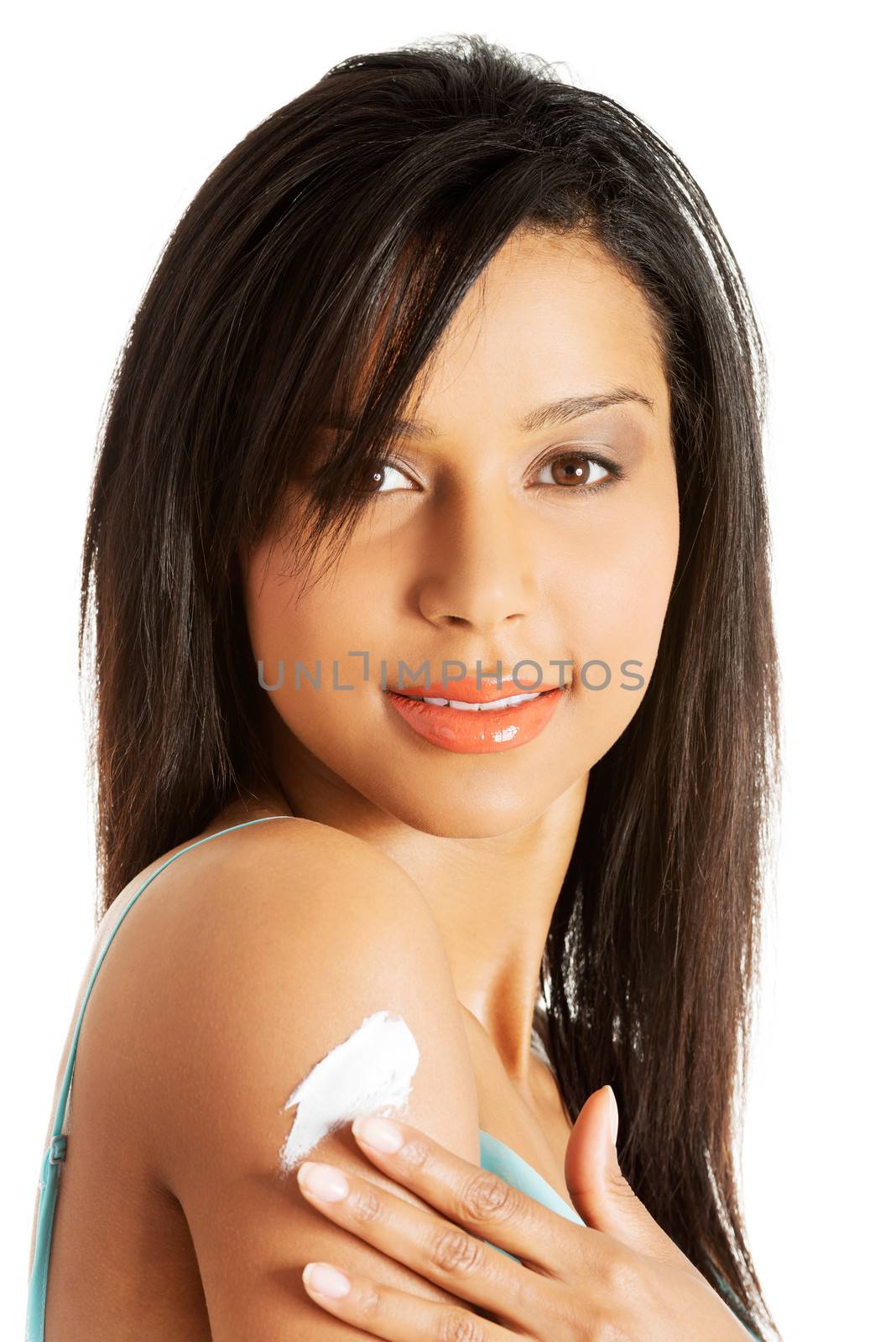 Beautiful woman with healthy skin applying cosmetic cream on a clean fresh arm