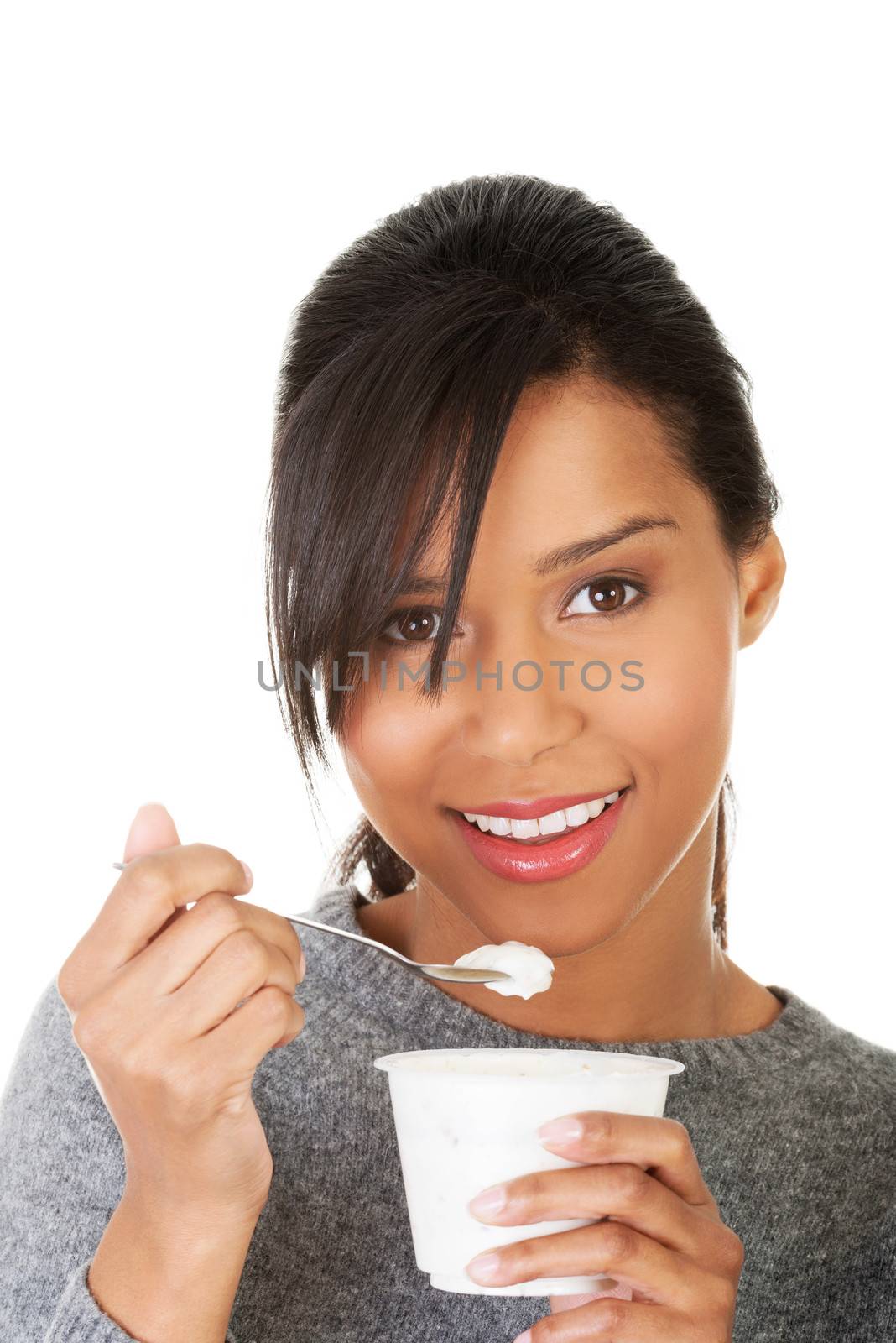 Young beautiful woman eating yogurt as healthy breakfast or snack. Isolated on white