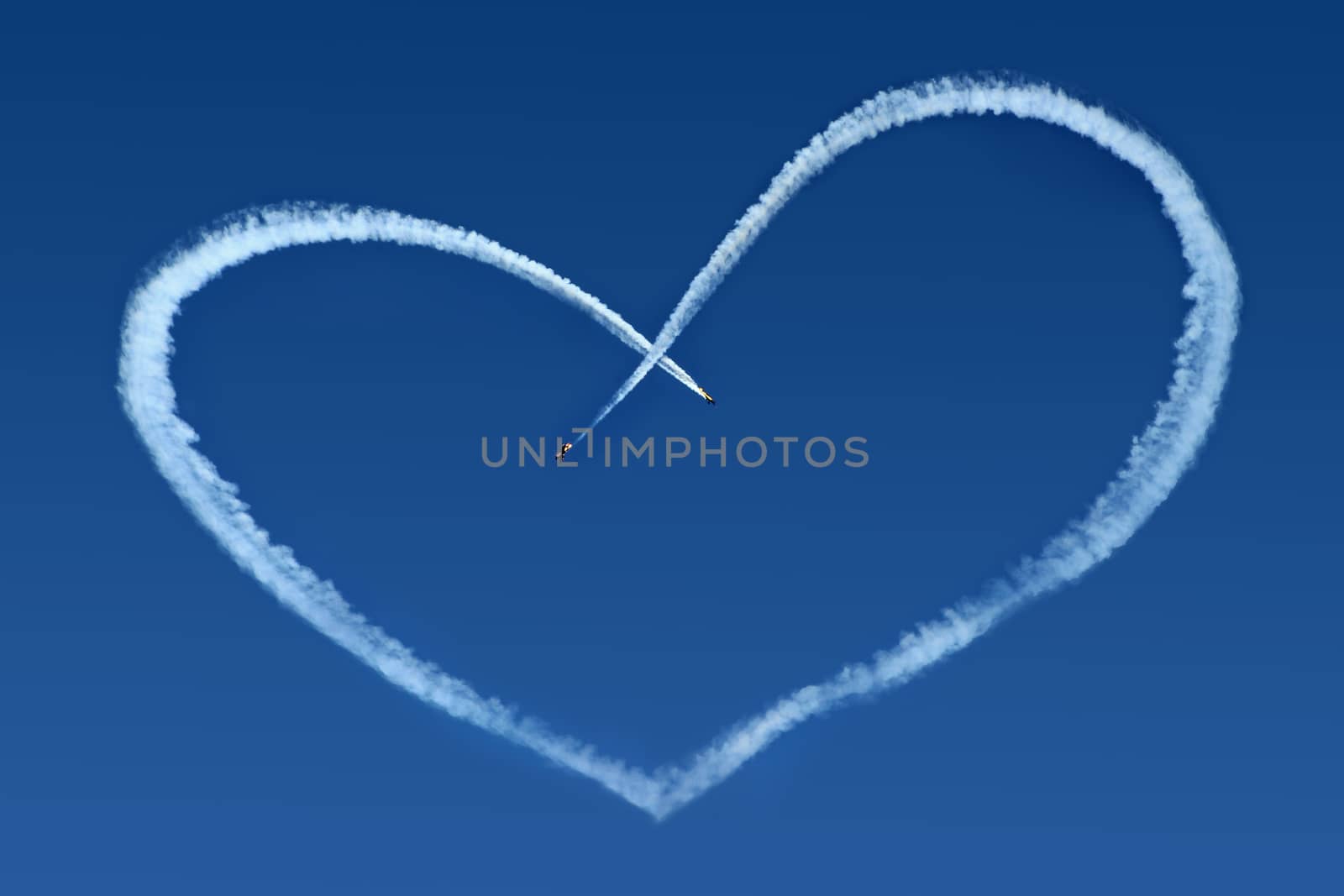 Airplanes Skywriting a Heart on blue sky