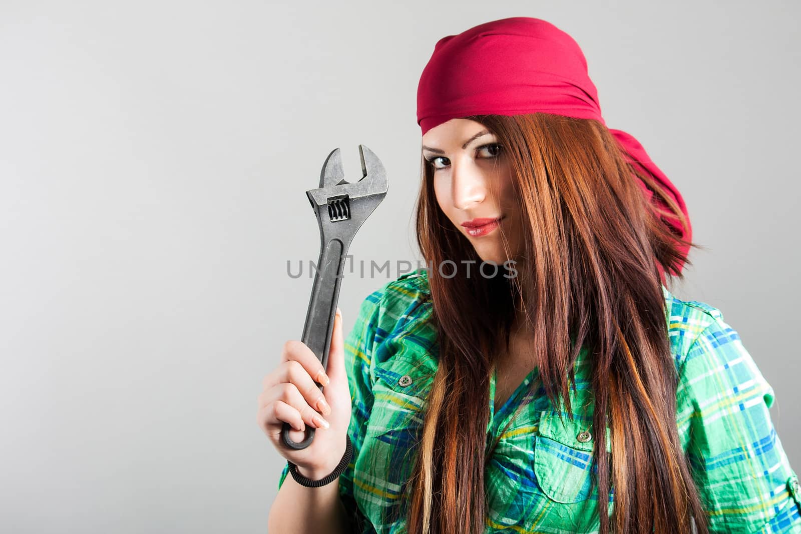 portrait of attractive girl holding adjustable wrench
