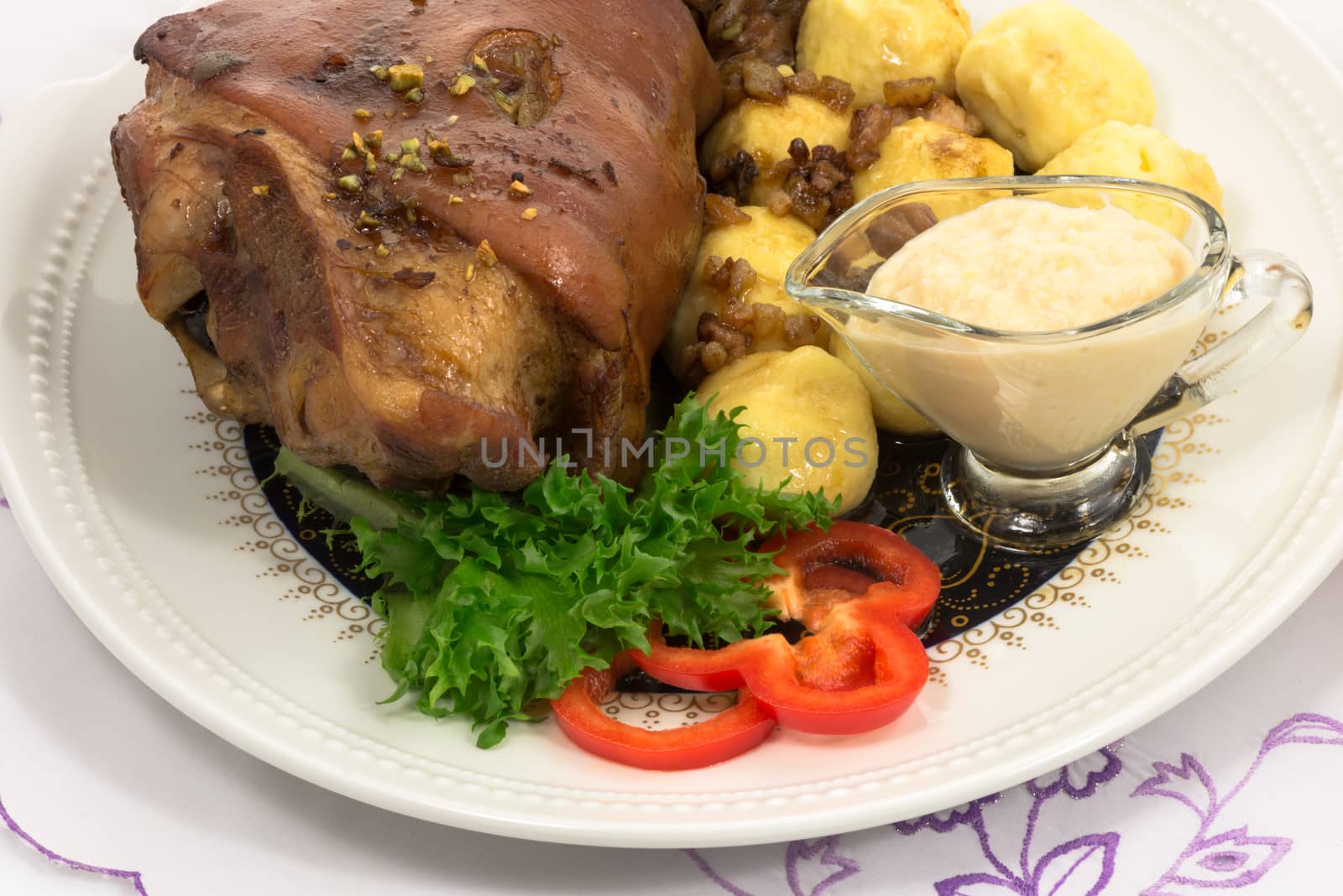 grilled knuckle of pork with potato dumplings with horseradish