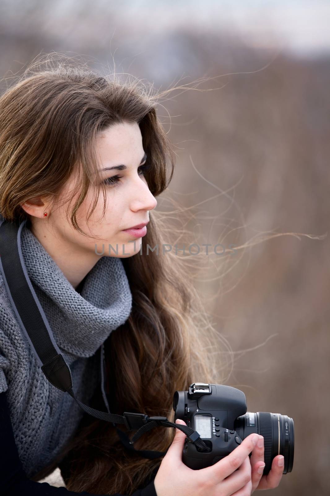 Female photographer with camera in hand